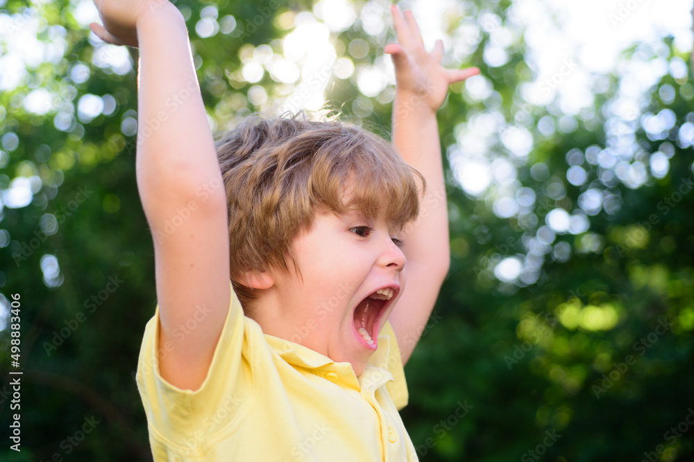 Excited kids. Portrait of adorable little boy on green background park in nature. Wow look. Portrait of amazed cute little boy with curly hair, surprised outdoors. Excited kids. Portrait of adorable little boy on green background park in nature. Wow look. Portrait of amazed cute little boy with curly hair, surprised outdoors.
