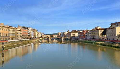 iew of the city of florence in Italy from river Arno with reflection of colorful buildings on the water photo