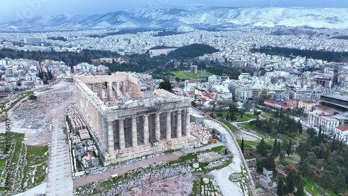 snow in Athens, flying around the Parthenon, aerial view of famous Greek tourist destination in winter, tourism in Greece concept photo