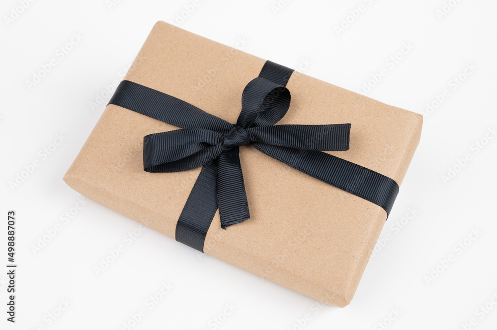 Craft gift box on a white background, decorated with black ribbon. For birthday, anniversary presents, gift post cards. Craft gift box on a white background, decorated with black ribbon. For birthday, anniversary presents, gift post cards.