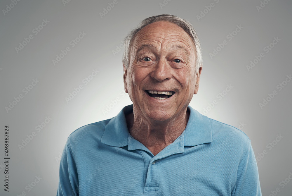 Time to smile for a while. Shot of a man happily smiling at the camera in a studio against a grey background. Time to smile for a while. Shot of a man happily smiling at the camera in a studio against a grey background.