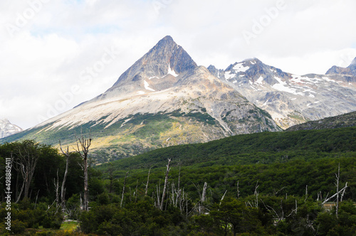 Mountain peaks covered with snow and hills with grass and vegetation