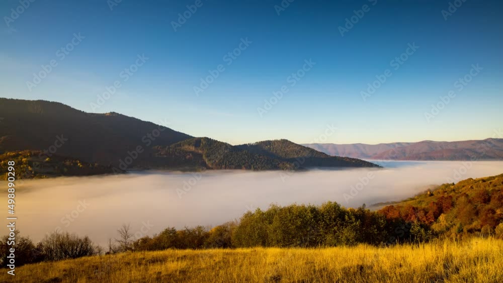 Thick morning fog fills highland deep valley among mountains Thick morning fog fills highland deep valley among mountains