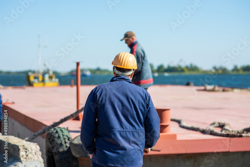 Принти на полотні dock workers on a river barge in the port