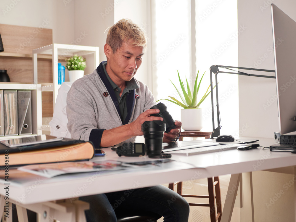 Graphic designer/photographer working in home office Graphic designer/photographer working in home office