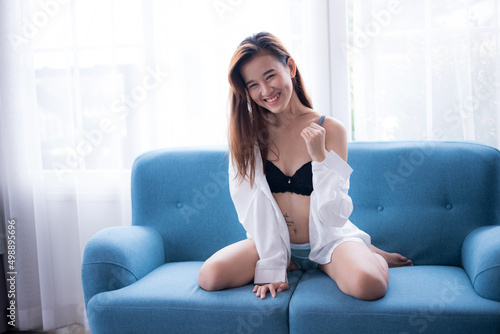 Bikini. Asian women wearing bikinis, posing in a studio room.	