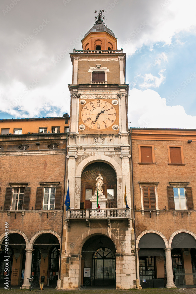 the municipal tower located at Piazza Grande in Modena, Italy. In the center of the tower there is an ancient clock.