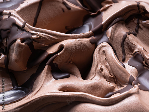 Chocolate flavour gelato - full frame detail. Close up of a brown surface texture of chocolate Ice cream covered with dark chocolate topping.