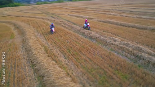 Motorcycle drivers traveling on a country road. Aerial view of motocrossing landscapes. photo