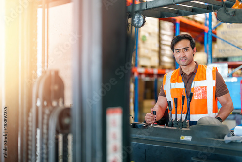 Man worker driving forklift in warehouse. Warehouse and Logistic business concept.