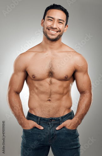 I paid with blood, sweat and tears for this body. Shot of a handsome young man standing alone and posing shirtless in the studio.