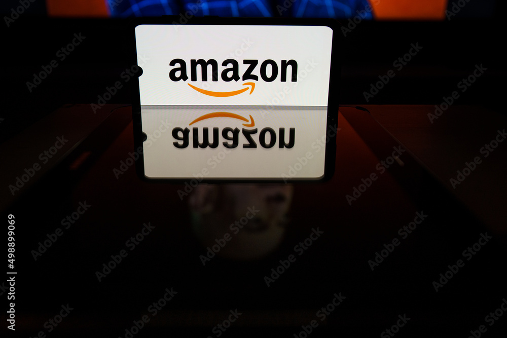 Amazon logo on screen and Jeff Bezos is a Executive Chairman of Amazon in background Stock Photo