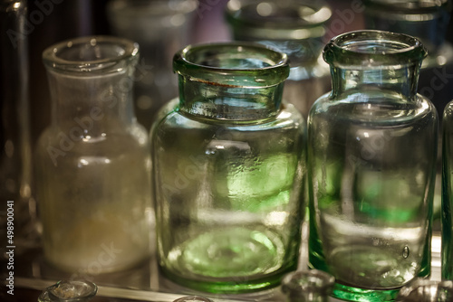 Pharmacy flasks old, antique medical glass containers bottles for medicines, selective focus.