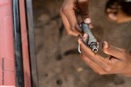 african man fixing on a generator