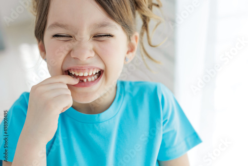 The kid lost a tooth. Baby without a tooth. Portrait of a little girl no tooth. High quality photo photo