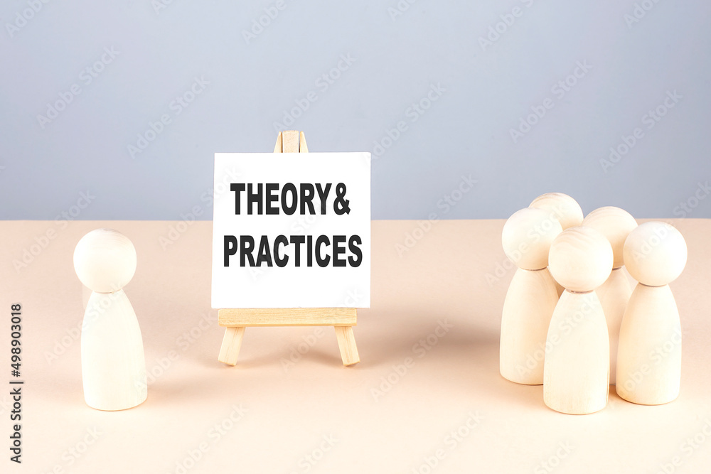 THEORY AND PRACTICES text on easel with wooden figure, meeting concept THEORY AND PRACTICES text on easel with wooden figure, meeting concept