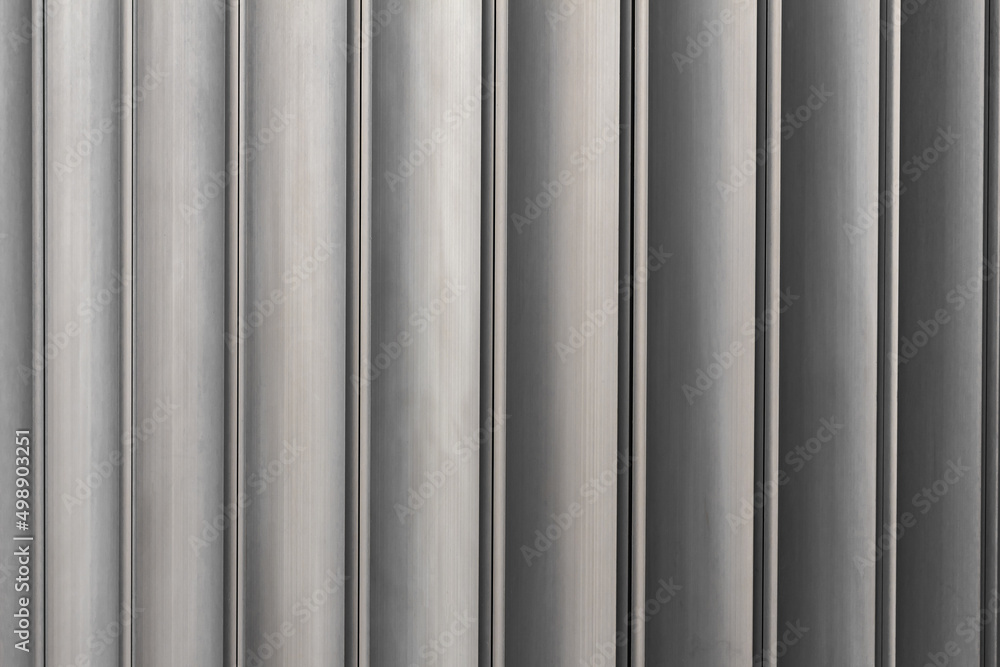 Close-up, texture of metal profiled neutral color palette. Grunge brown Metal Wall, columns Close-up, texture of metal profiled neutral color palette. Grunge brown Metal Wall, columns