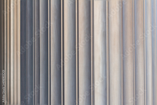 Close-up, texture of metal profiled. Aluminium Siding Panel Profile Grunge brown Metal Wall, columns