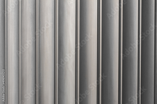 Close-up, texture of metal profiled neutral color palette. Grunge brown Metal Wall, columns