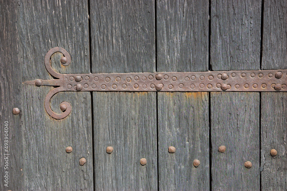 An old castle gate with rusty door hinge. Architectural detail. Retro ...