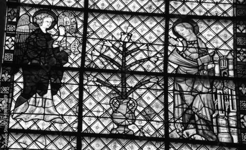 Annunciation of Angel Gabriel to the Blessed Virgin Mary on the stained glass window in Chartres cathedral. Chartres, France. Black white historic photo