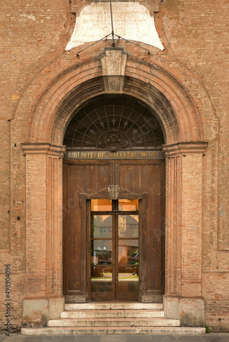 Door of a prestigious historic building with stone arch.