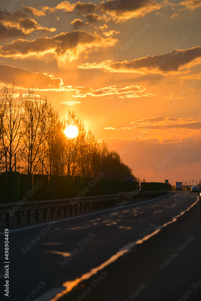 Driving on A2 highway in Romania from Bucharest to Constanta during an amazing sunrise. Sun view on the road, beautiful roads landscape. Transportation industry.