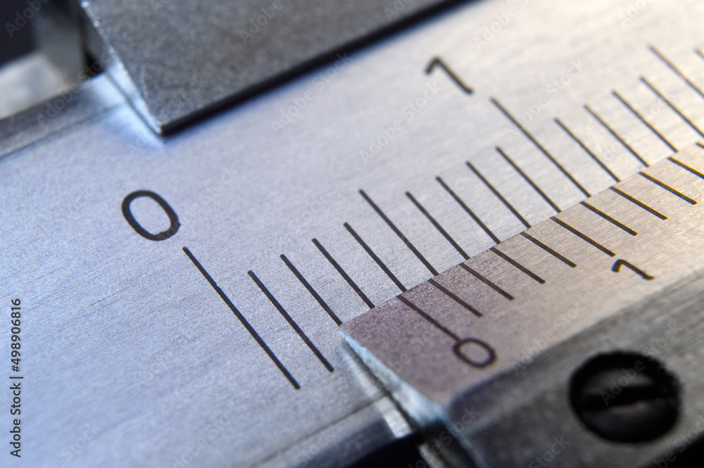 locksmith measuring tool lies on the background of metal rulers. close-up locksmith measuring tool lies on the background of metal rulers. close-up