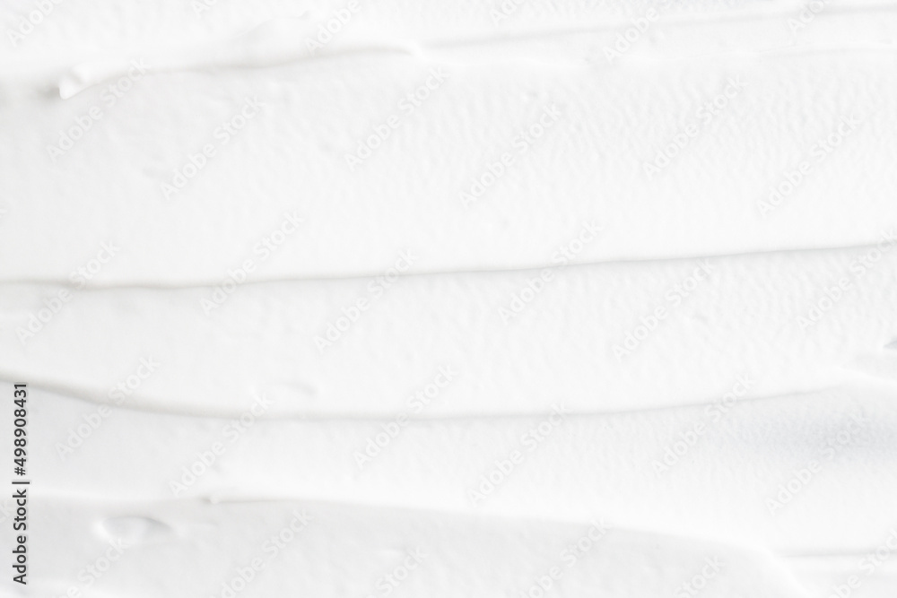 Obraz premium White cosmetic foam applied with brush strokes, top view.
