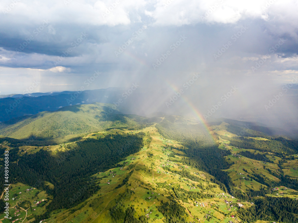 Rainbow in the mountains of the Ukrainian Carpathians. Aerial drone view.