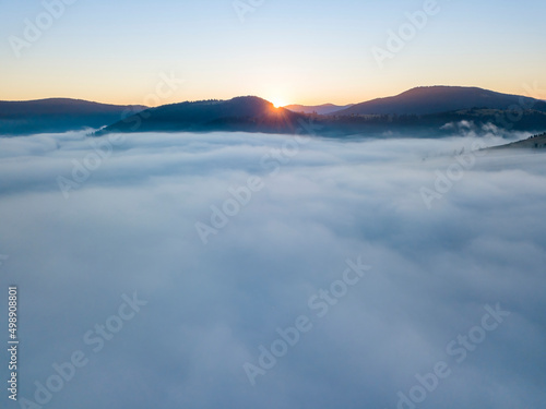 Sunrise over the fog in the Ukrainian Carpathians. Aerial drone view.