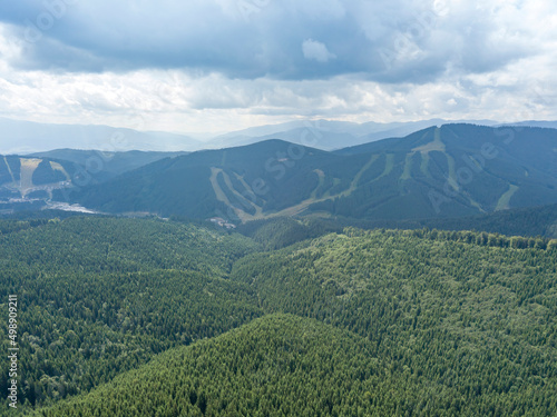 Green mountains of Ukrainian Carpathians in summer. Sunny day  rare clouds. Aerial drone view.