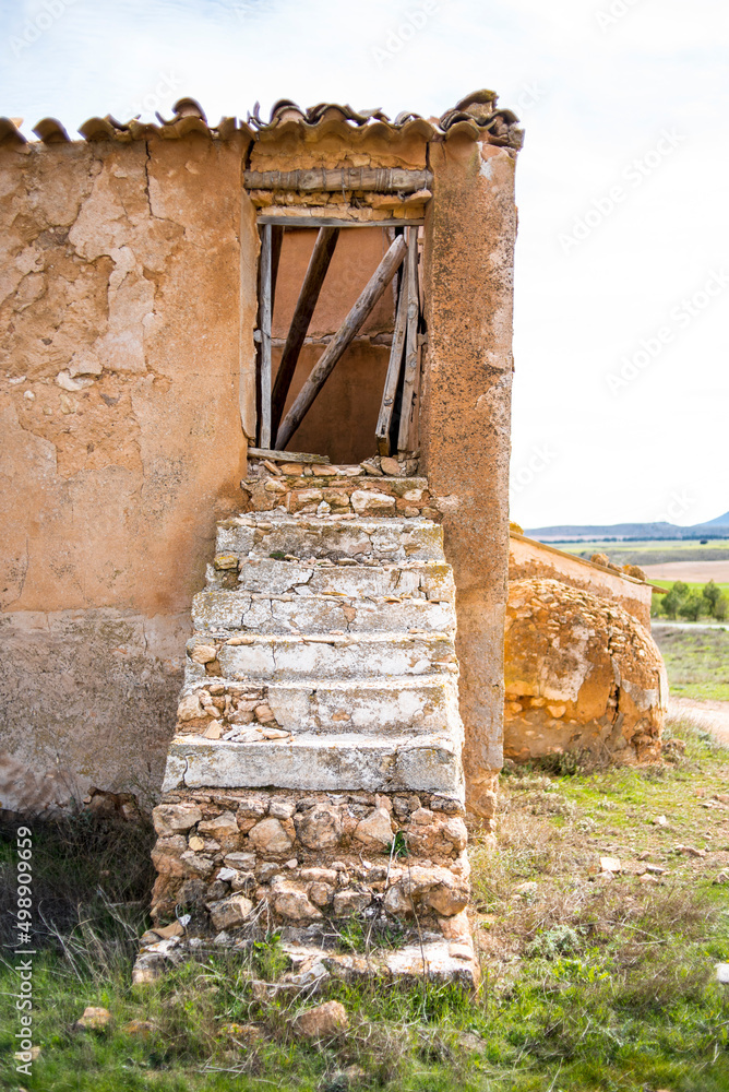 Old stone and adobe staircase in a ruined house, uninhabited Spain.