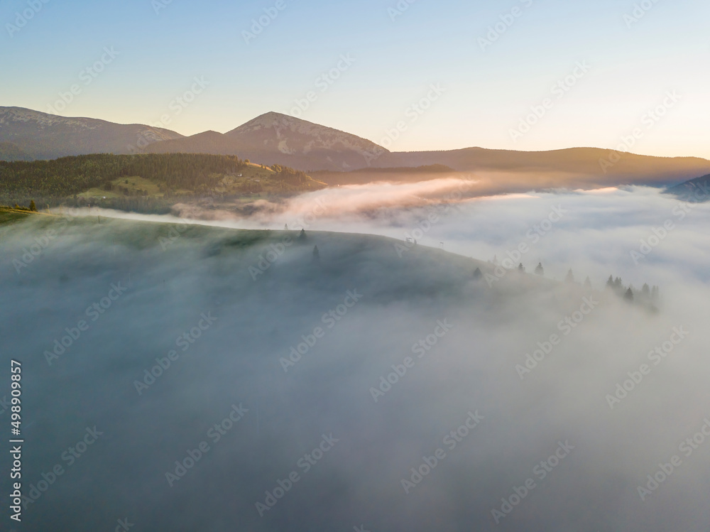 Sunrise over the fog in the Ukrainian Carpathians. Aerial drone view. Sunrise over the fog in the Ukrainian Carpathians. Aerial drone view.