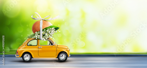 Photography Yellow car carrying an easter egg atop with lilies of the valley bunch