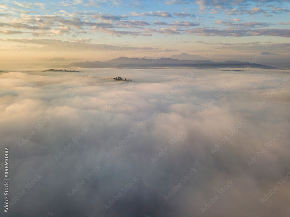 Fototapeta premium Sunrise over the fog in the Ukrainian Carpathians. Aerial drone view.