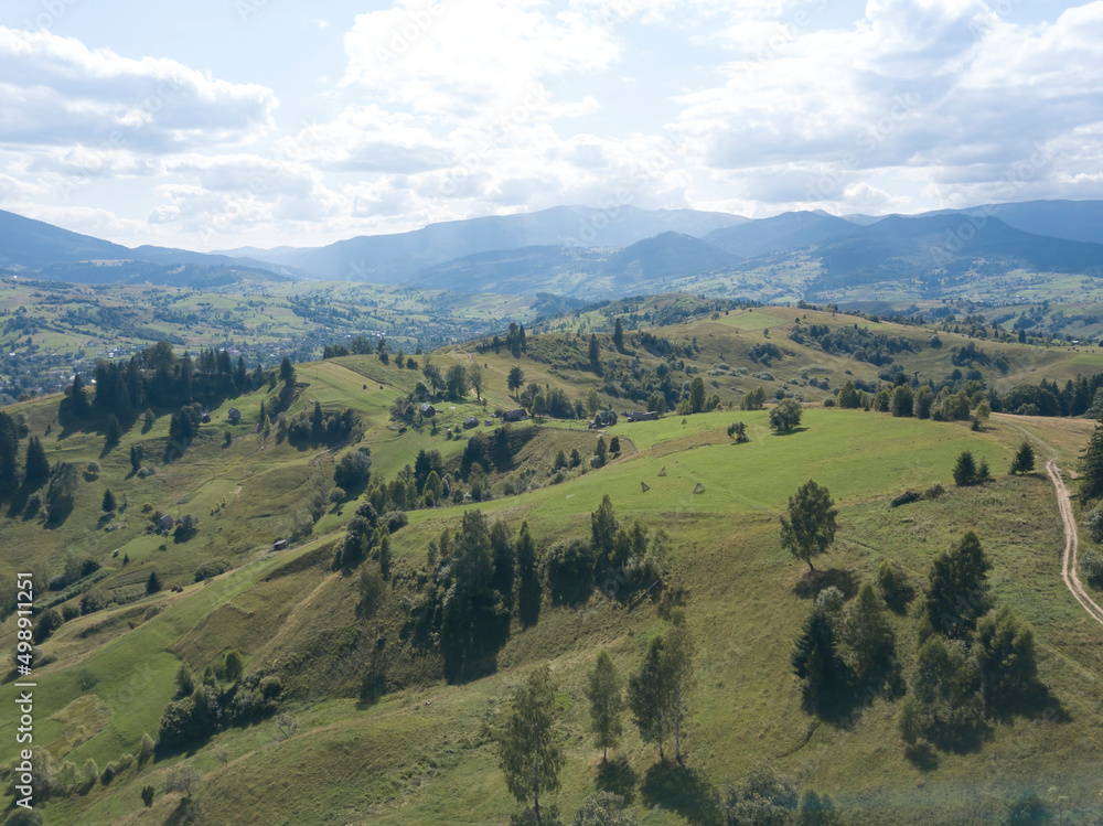 Green mountains of Ukrainian Carpathians in summer. Coniferous trees on the slopes. Aerial drone view. Green mountains of Ukrainian Carpathians in summer. Coniferous trees on the slopes. Aerial drone view.
