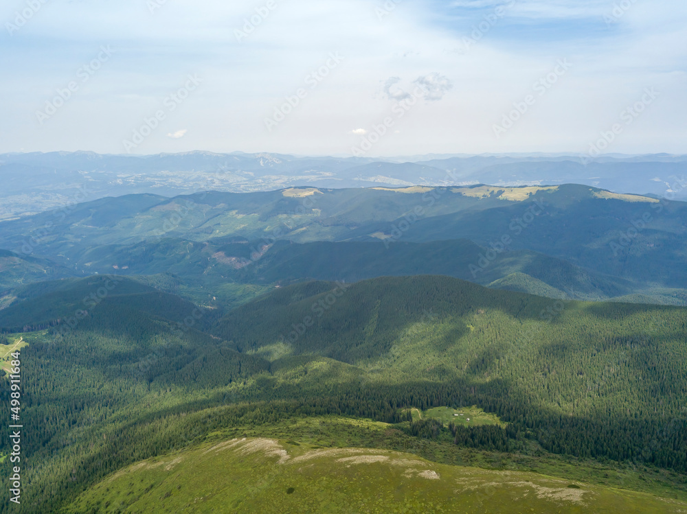 High mountains of the Ukrainian Carpathians in cloudy weather. Aerial drone view.