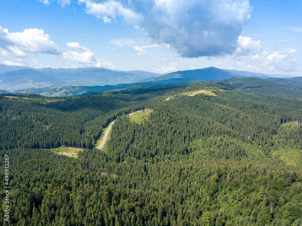 Green mountains of Ukrainian Carpathians in summer. Sunny day. Aerial drone view.