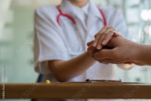 The doctor shook the patient's hand to offer advice and encouragement at the table. or describe the abnormalities of the patient's body in the hospital