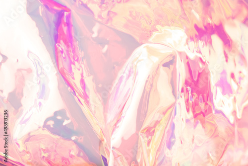 Blurred colorful holographic background. Defocused textured gradient in pink colors.