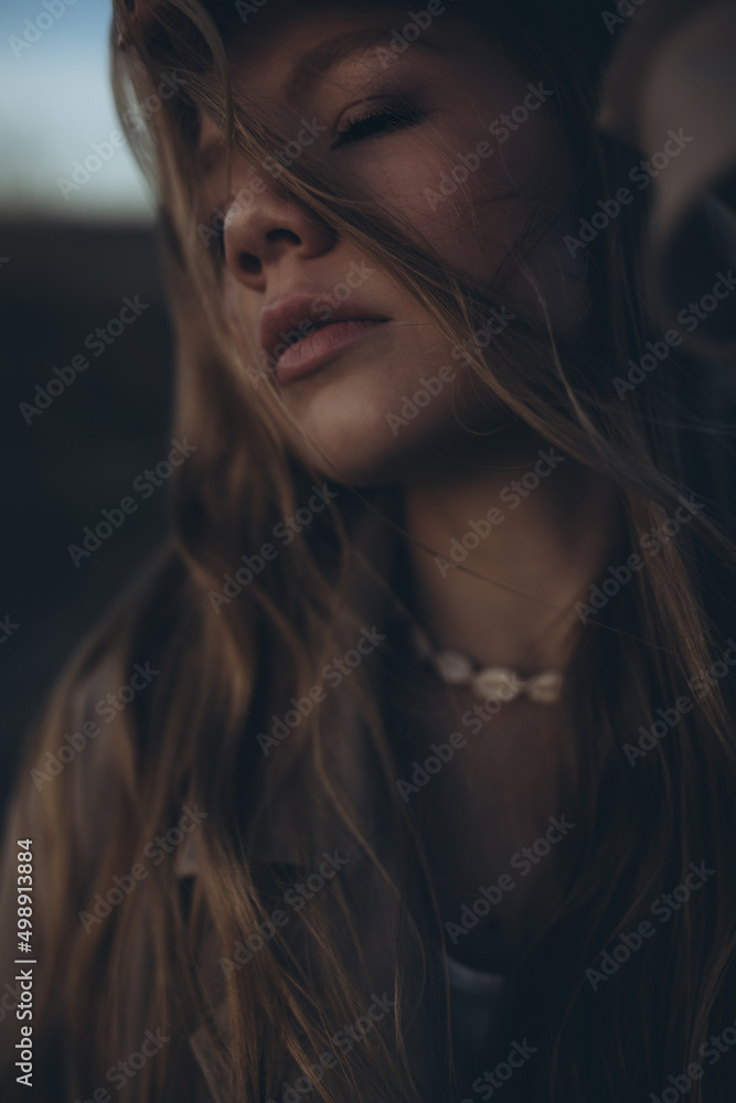 Beautiful young girl at sunset by the sea. High quality photo Beautiful young girl at sunset by the sea. High quality photo