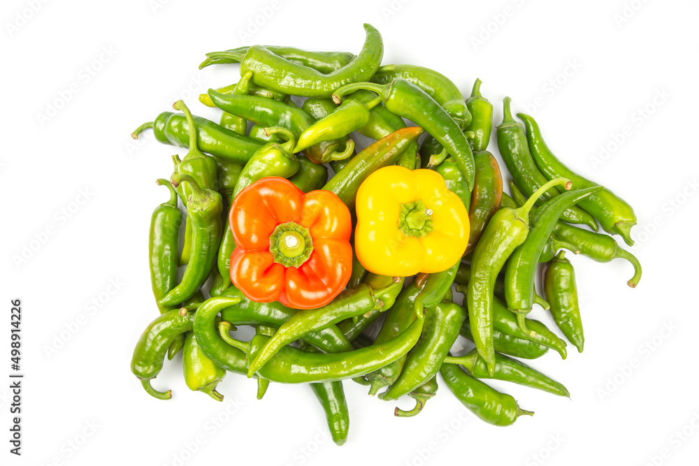 green hot peppers and red and yellow bell peppers on a white background. vitamin vegetables for health