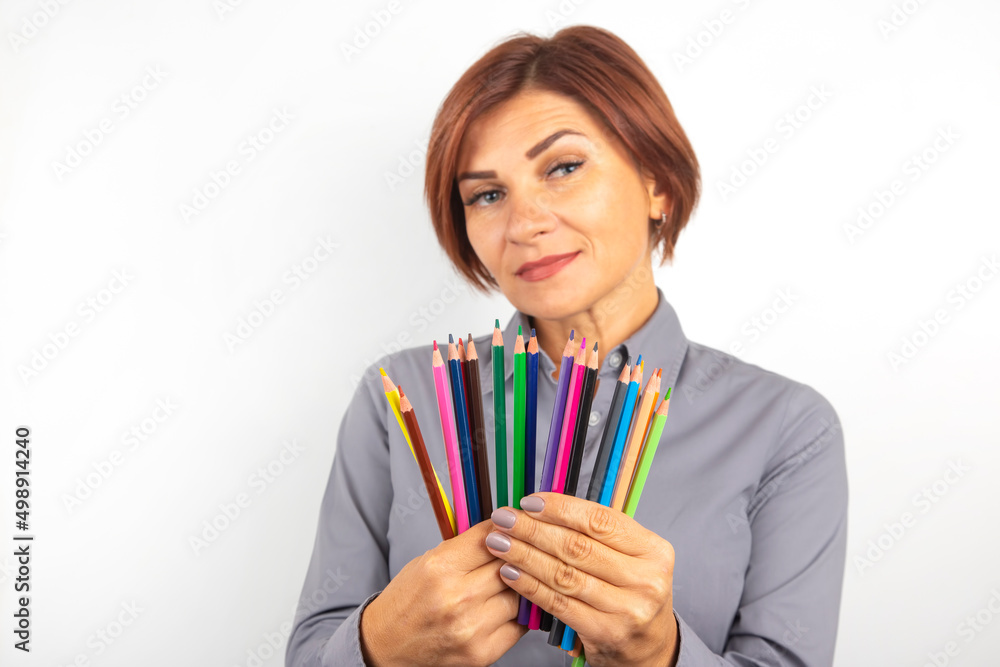 woman demonstrates colored pencils in her hands. woman demonstrates colored pencils in her hands.