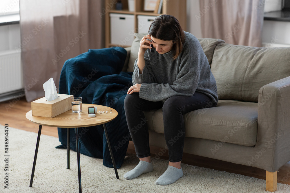 mental health, psychological help and depression concept - stressed woman with sedative medicine on table calling on phone at home