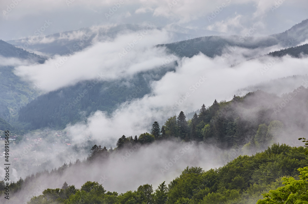 Majestic view on beautiful fog mountains in mist landscape. Dramatic unusual scene. Travel background. Exploring beauty world. Majestic view on beautiful fog mountains in mist landscape. Dramatic unusual scene. Travel background. Exploring beauty world.