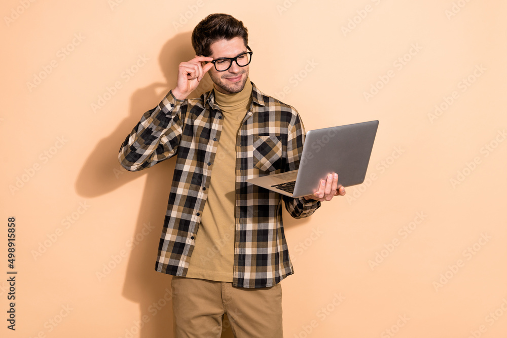 Photo of smart ceo guy using netbook read employees project webinar video isolated pastel color background Photo of smart ceo guy using netbook read employees project webinar video isolated pastel color background