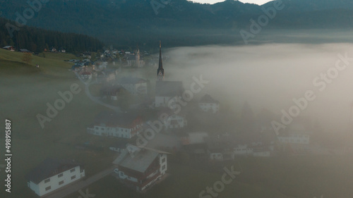 swiss alpine village fog morning