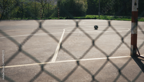 CLOSE-UP OF A NET, IN THE BACKGROUND A SOCCER BALL ON THE INDOOR SOCCER FIELD.