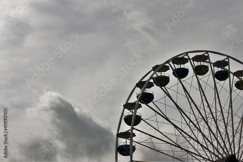 Close-up winter scene of some metal children's ferris wheel with cloudy sky in Germany